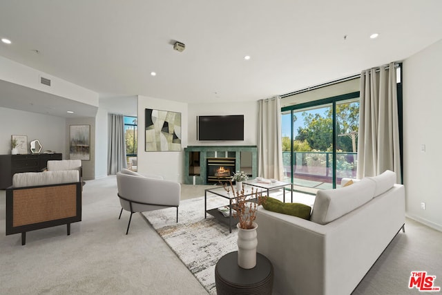 carpeted living room with a fireplace