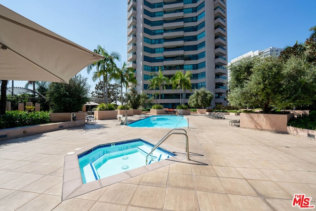 view of pool with a patio area and a community hot tub