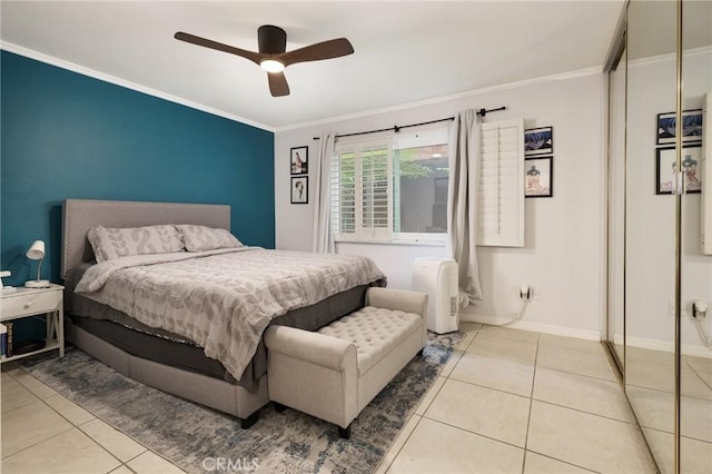 bedroom with a closet, ceiling fan, crown molding, and light tile patterned floors