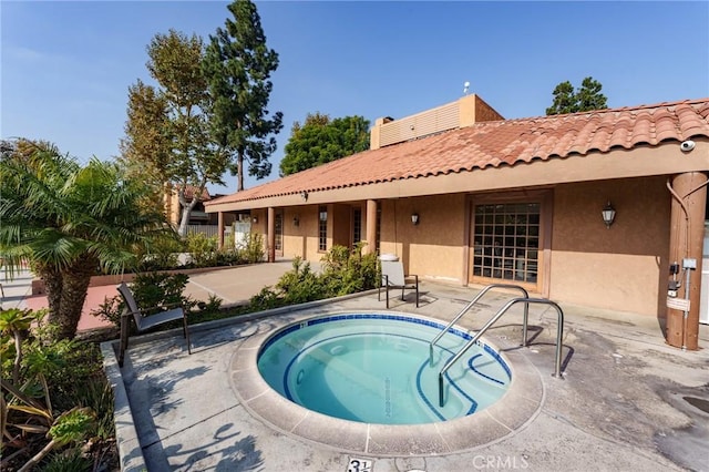 view of pool featuring a patio and a hot tub