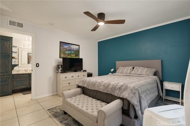 bedroom with ceiling fan, light tile patterned flooring, ornamental molding, and connected bathroom