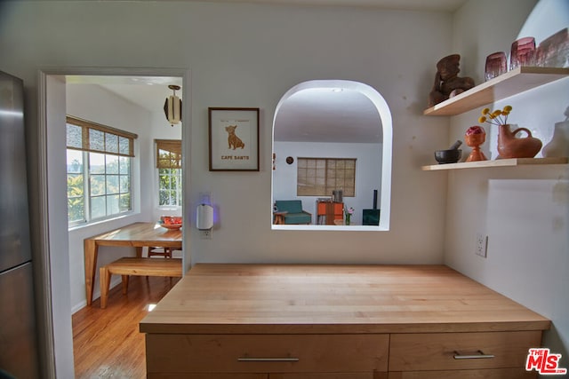 kitchen with wood counters and light hardwood / wood-style floors