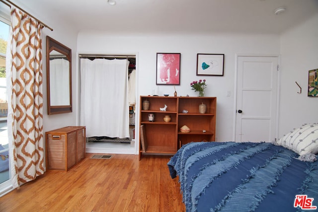 bedroom featuring a closet and light wood-type flooring