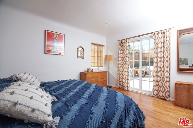 bedroom featuring access to exterior and light hardwood / wood-style flooring