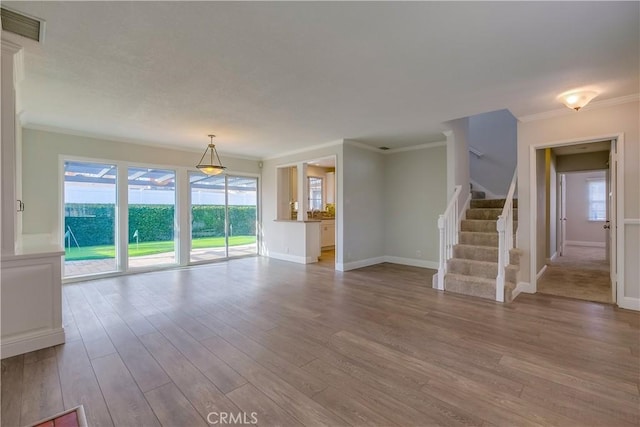 unfurnished living room with crown molding and light wood-type flooring