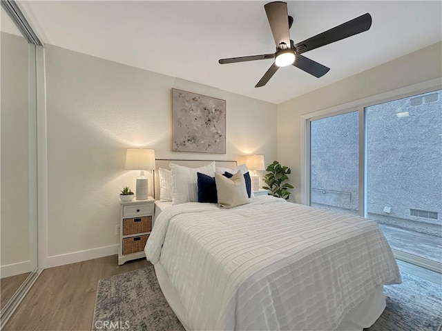 bedroom with access to outside, ceiling fan, and hardwood / wood-style floors