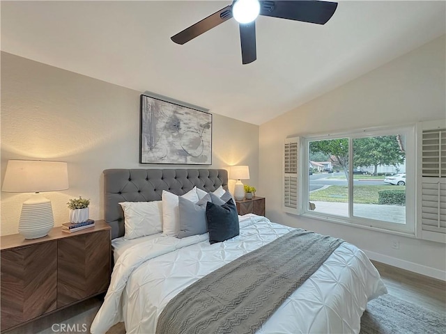 bedroom with ceiling fan, hardwood / wood-style floors, and lofted ceiling