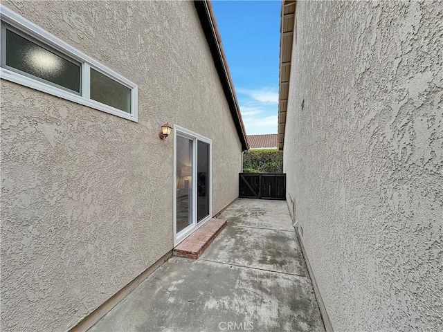 view of side of home with a patio