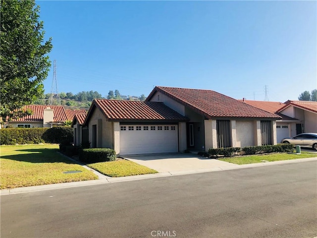 view of front of home featuring a garage and a front lawn