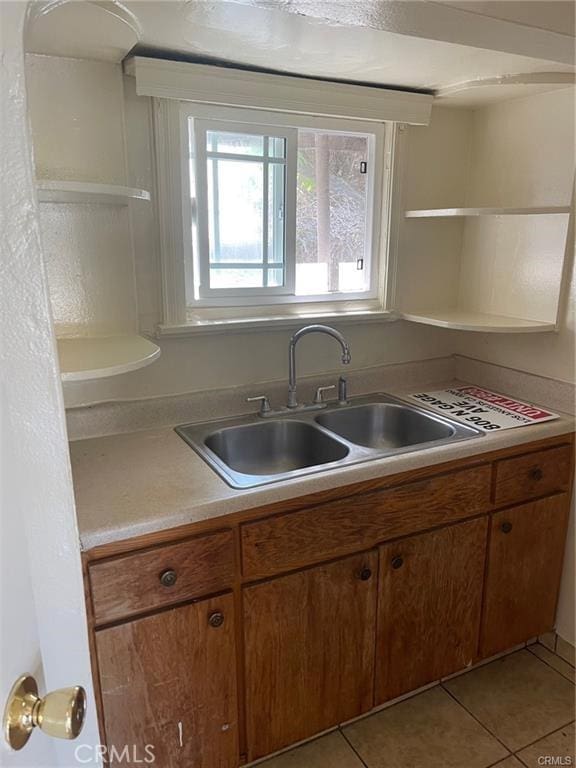 kitchen with sink and light tile patterned flooring