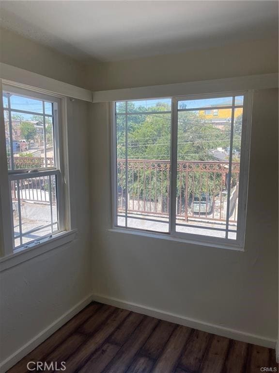 unfurnished room with hardwood / wood-style flooring and a wealth of natural light