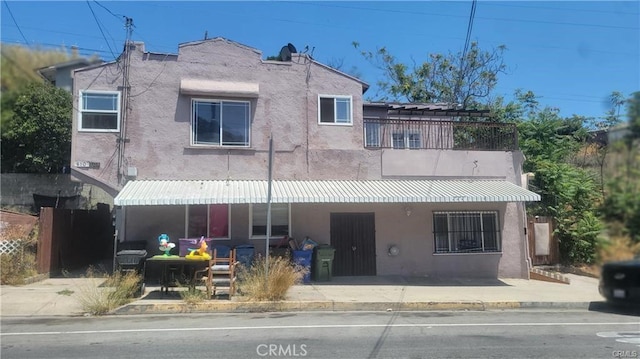 back of property with a balcony