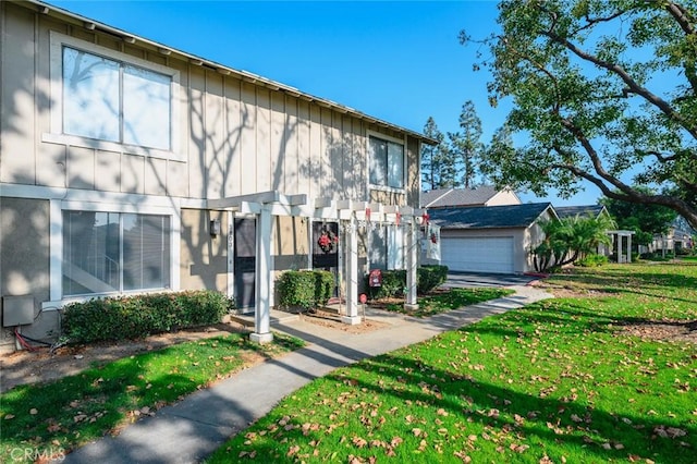 view of property with a front yard and a garage