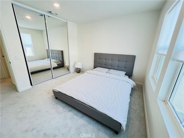 carpeted bedroom featuring a closet