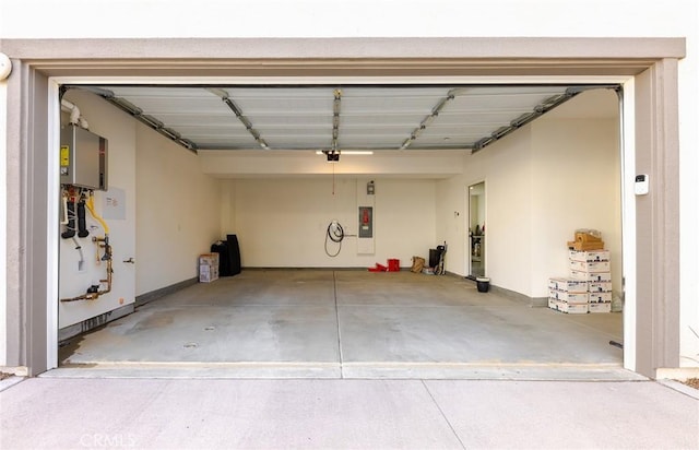 garage with water heater, a garage door opener, and electric panel