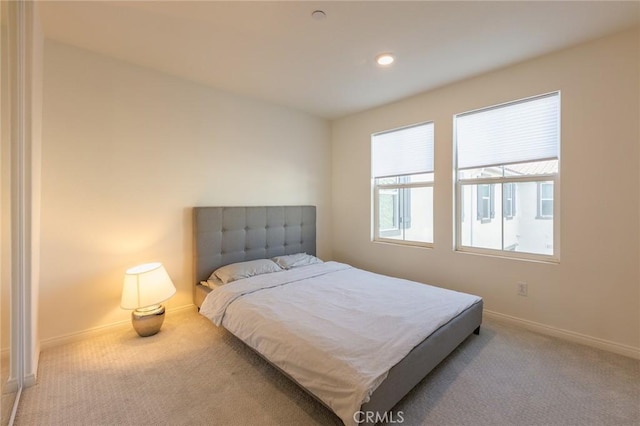 bedroom featuring light carpet