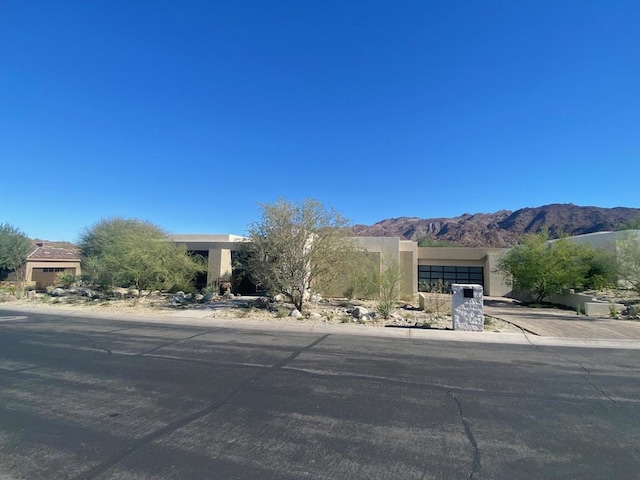 view of front of house featuring a garage and a mountain view