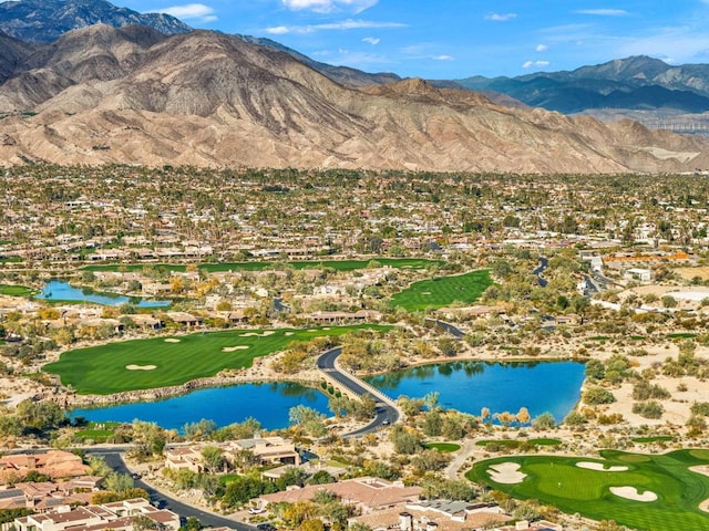 birds eye view of property with a water and mountain view