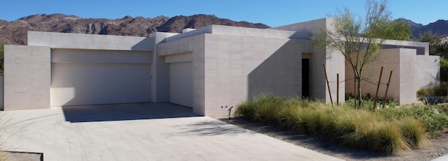 exterior space featuring a garage and a mountain view