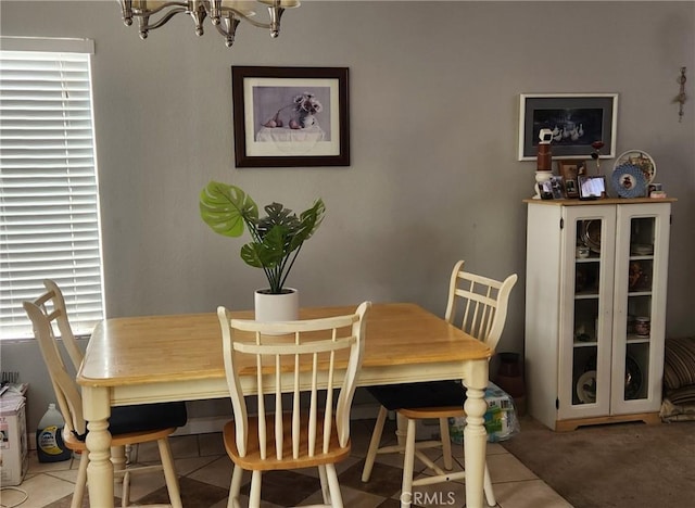 carpeted dining space with a notable chandelier