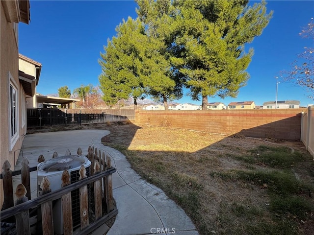 view of yard featuring a patio area and central air condition unit