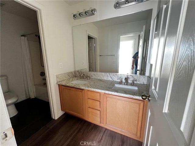 full bathroom featuring shower / tub combination, toilet, vanity, and hardwood / wood-style flooring