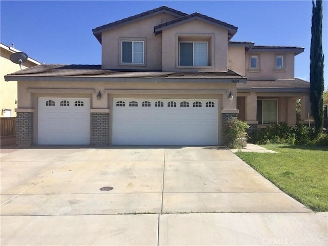 view of front of property featuring a front lawn and a garage