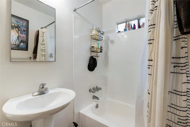 bathroom featuring sink and shower / bathtub combination with curtain