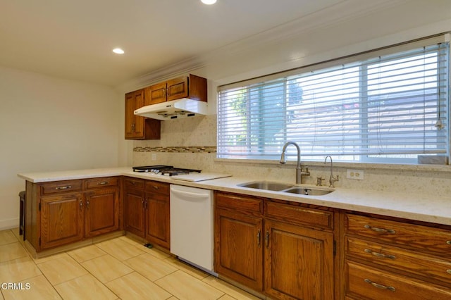 kitchen featuring crown molding, white appliances, decorative backsplash, and sink