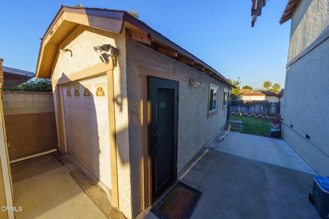 view of side of home with an outbuilding and a garage