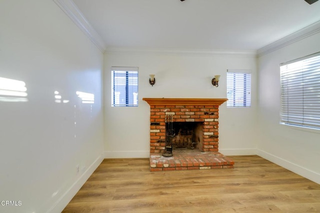 unfurnished living room with a brick fireplace, ornamental molding, and light hardwood / wood-style floors