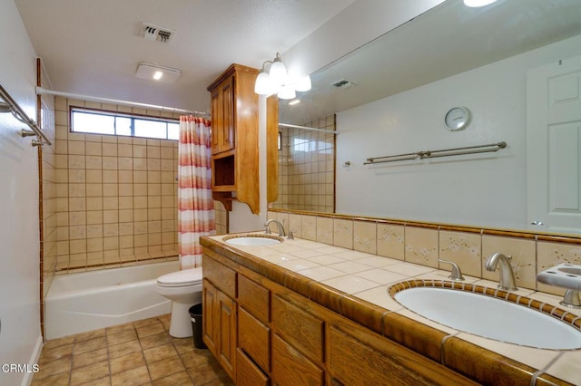 full bathroom featuring toilet, vanity, decorative backsplash, and shower / bath combo