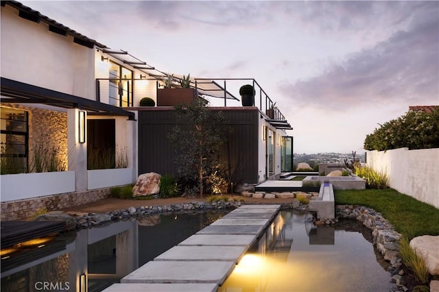 exterior space featuring a swimming pool with hot tub