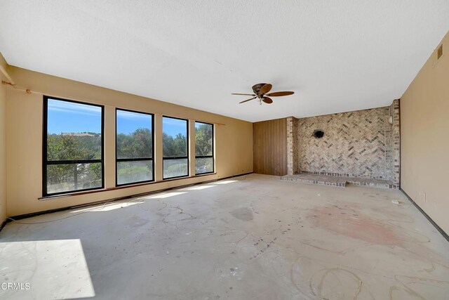 spare room featuring plenty of natural light and ceiling fan