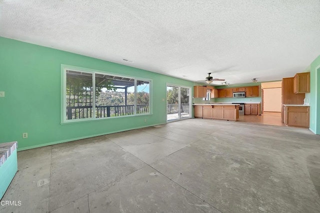 unfurnished living room with a textured ceiling and ceiling fan