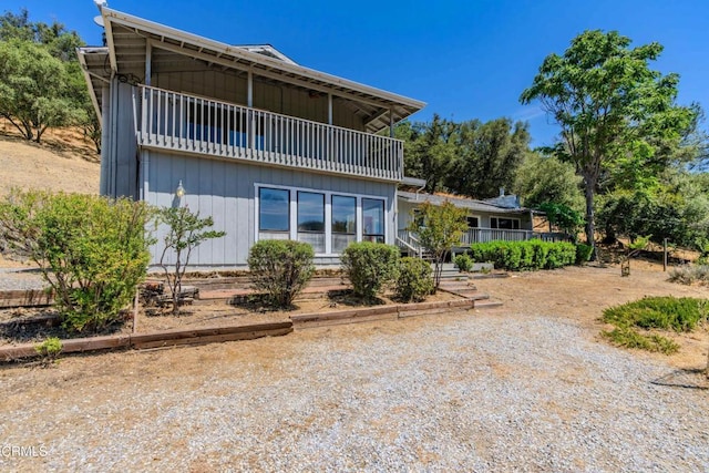 back of property with a balcony