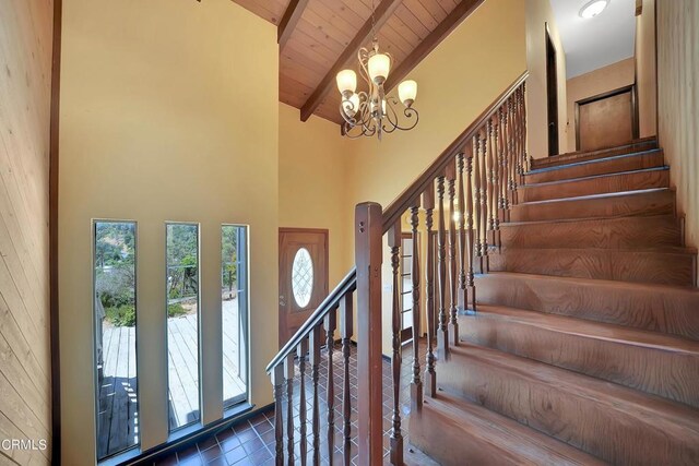 entrance foyer with beamed ceiling, wood ceiling, high vaulted ceiling, and a chandelier