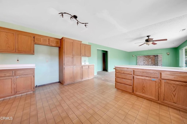 kitchen featuring light tile patterned floors, a textured ceiling, and ceiling fan