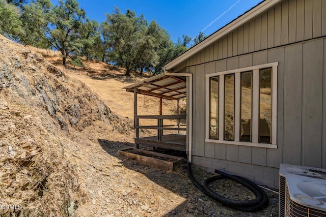 view of side of home featuring cooling unit