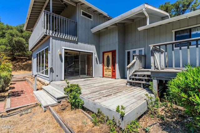 entrance to property with a balcony and a wooden deck