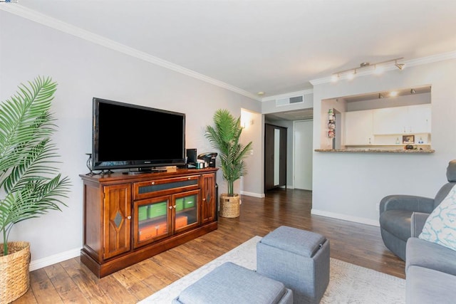 living room with crown molding and dark hardwood / wood-style flooring