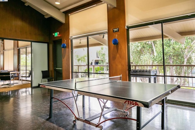 playroom featuring beamed ceiling and high vaulted ceiling