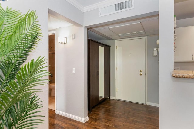 corridor featuring dark hardwood / wood-style flooring and ornamental molding