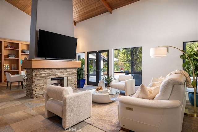 living room with wooden ceiling, a fireplace, french doors, high vaulted ceiling, and beamed ceiling