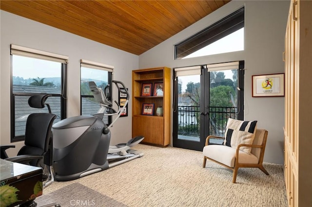 exercise room with vaulted ceiling, wood ceiling, light carpet, and french doors