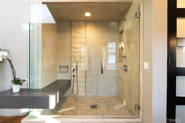 bathroom featuring a shower with shower door