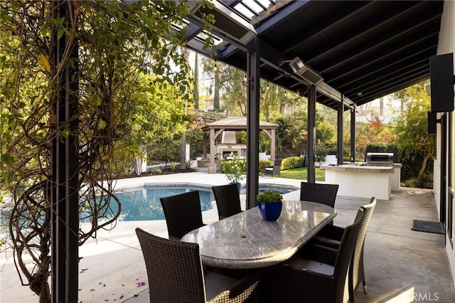 view of patio featuring exterior fireplace, exterior kitchen, and an outdoor bar