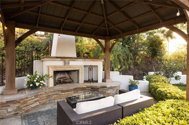 view of patio / terrace featuring a gazebo and a large fireplace