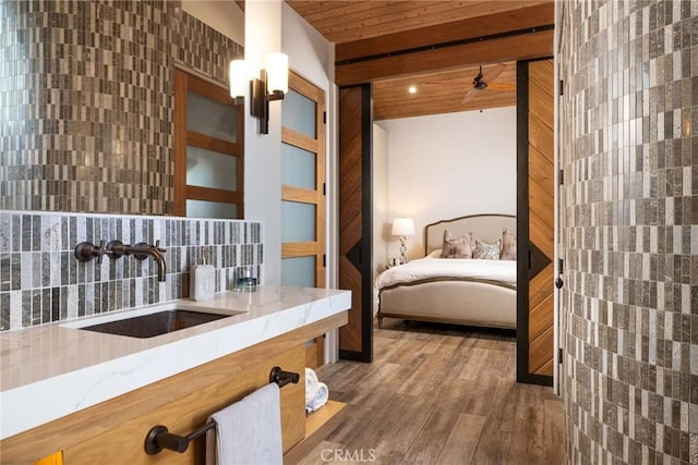 bathroom with vanity, beamed ceiling, backsplash, hardwood / wood-style flooring, and wooden ceiling