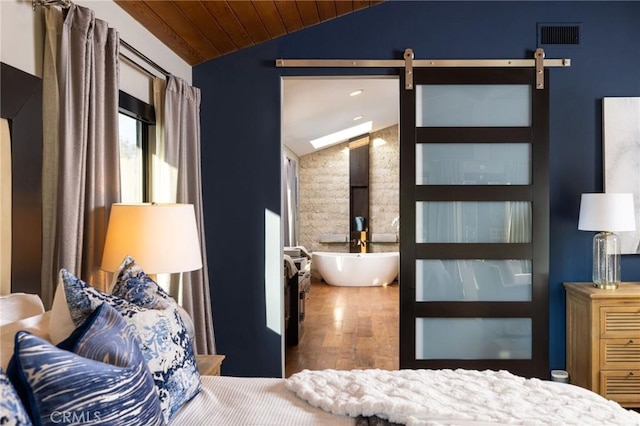 bedroom with wooden ceiling, lofted ceiling, a barn door, and hardwood / wood-style flooring